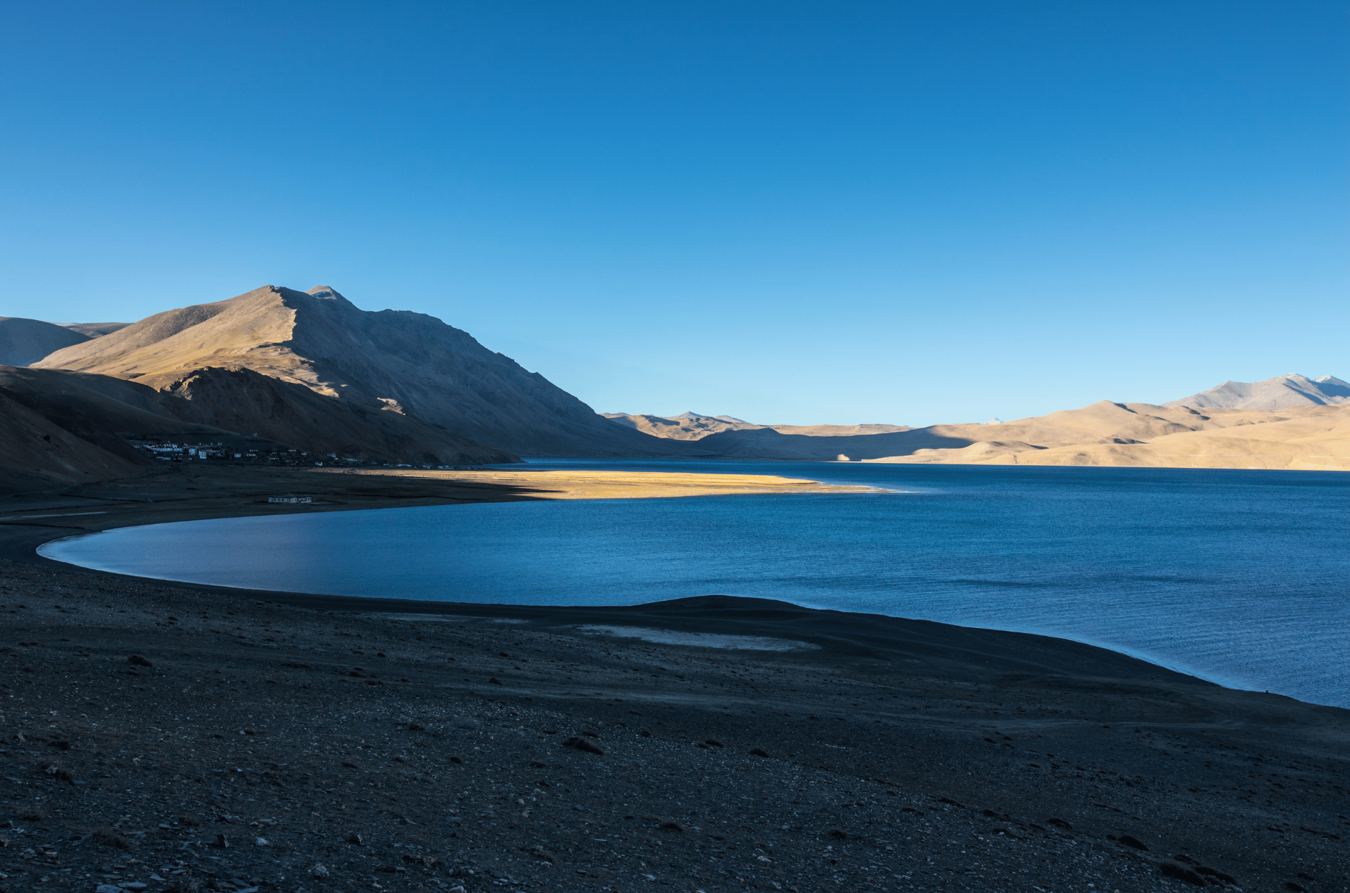 High-altitude blue lake framed by bare mountains in Leh Ladakh